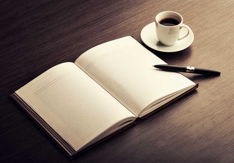 白色笔记本和一杯咖啡