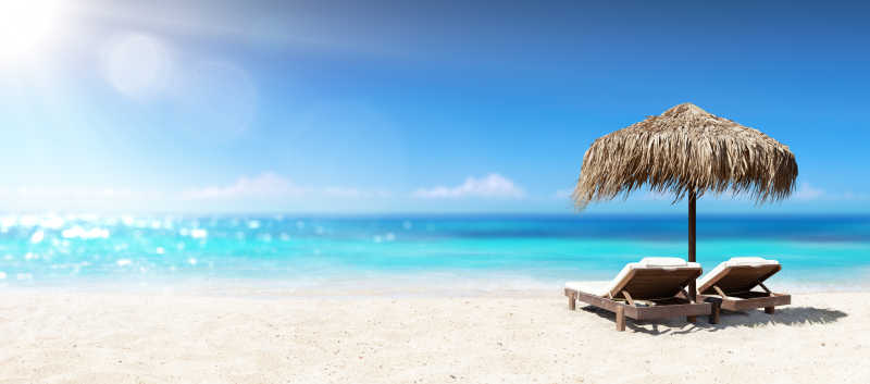 夏日阳光下的沙滩和休闲躺椅
