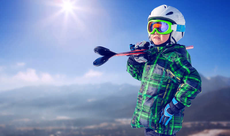 山上滑雪装备齐全的男孩