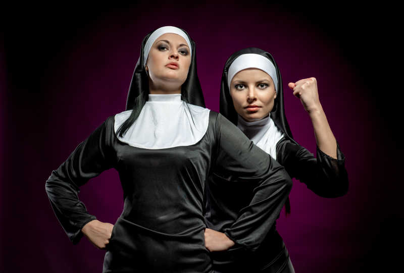 深色背景上的两个修女