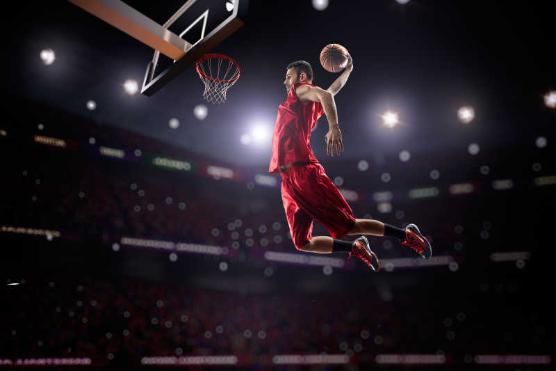 红衣篮球运动员飞身单手灌篮特写