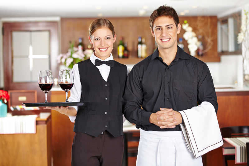两个餐厅服务员和红酒