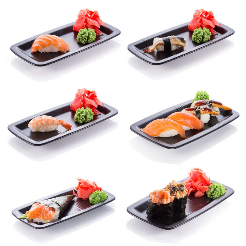 白色背景下在黑盘子上不同的寿司