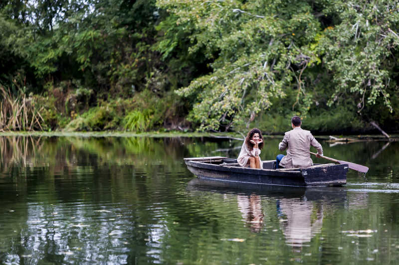 在湖面上划船的年轻夫妇