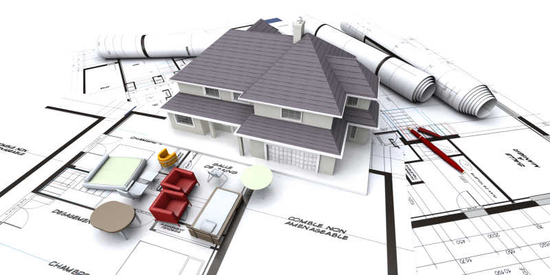 房子模型对建筑师卷起的蓝图计划和微型家具