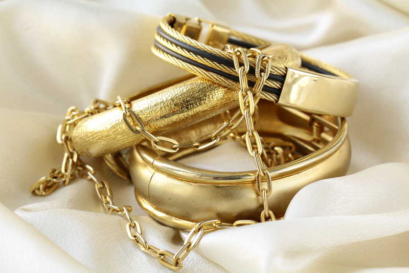 白绸布上的金手镯和金项链