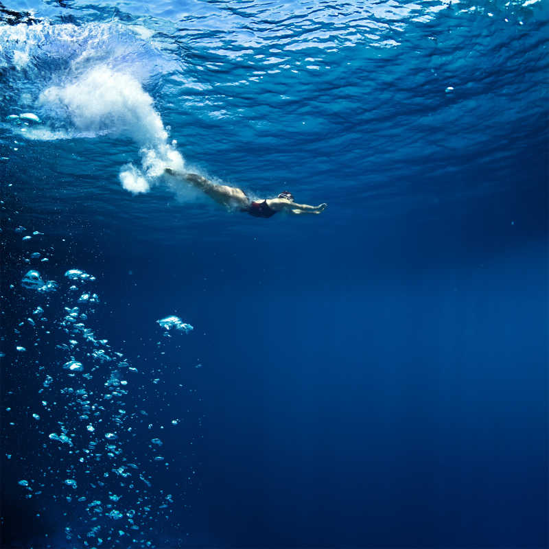 专业的女游泳运动员是刚刚跳进深蓝色的海洋气泡踪迹152152561115