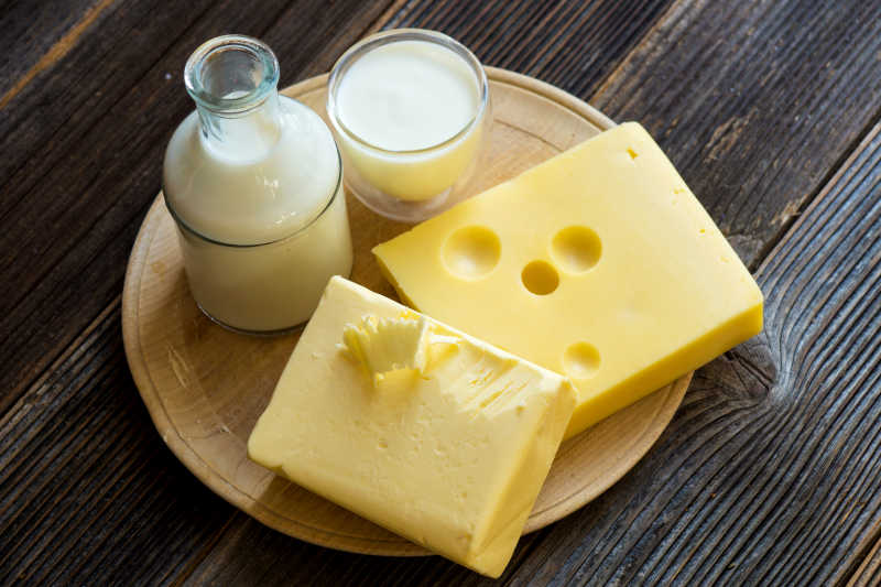 木材背景下的牛奶和奶酪