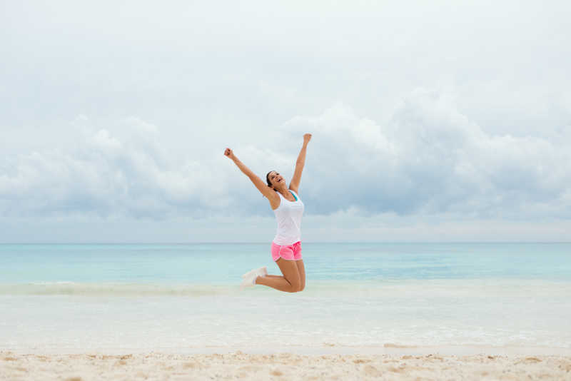 海滩上跳跃的女孩