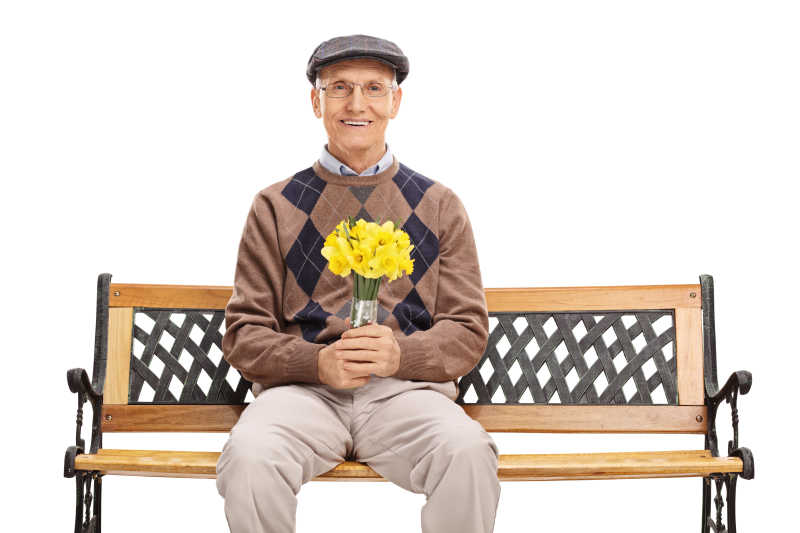 长凳上手拿鲜花的老人