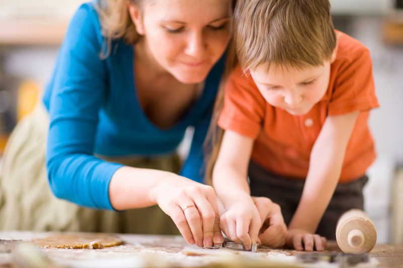 母亲和儿子在厨房做饼干