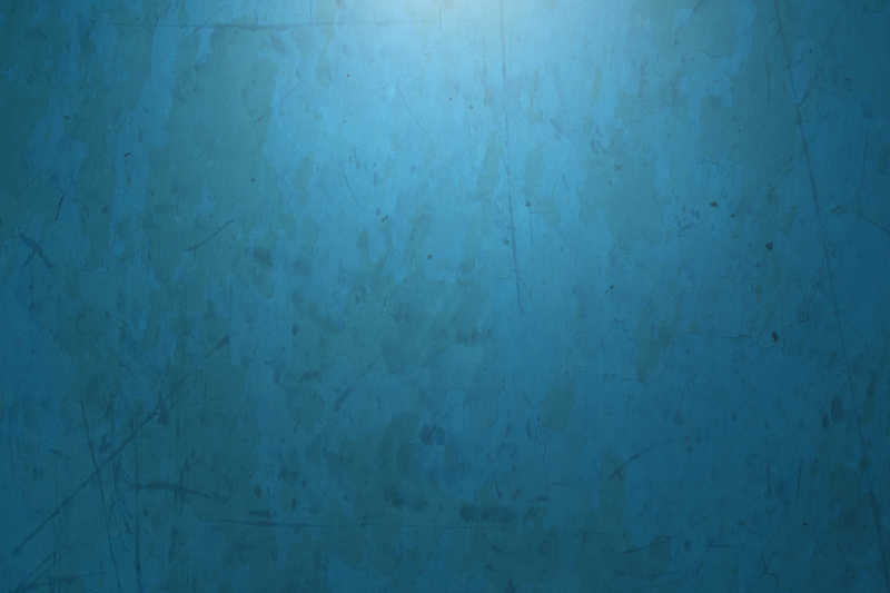 柔光照射下的蓝色斑驳的墙壁背景