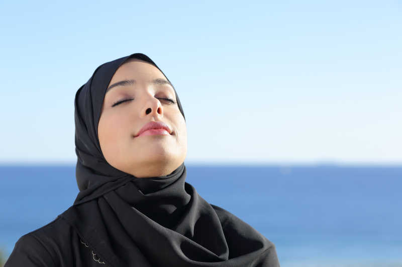 沙特妇女在海滩上呼吸着清新的空气