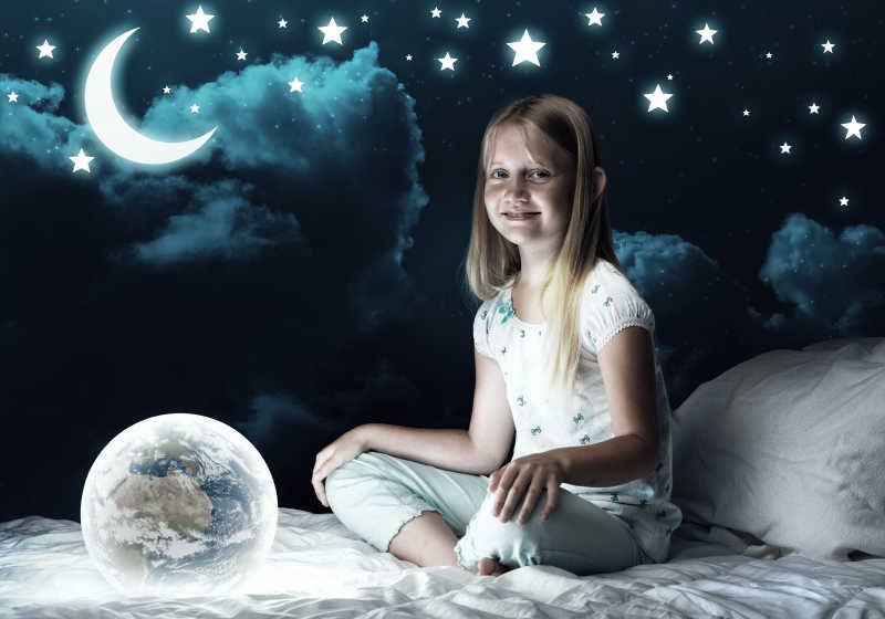 女孩在她的床和发光的地球仪