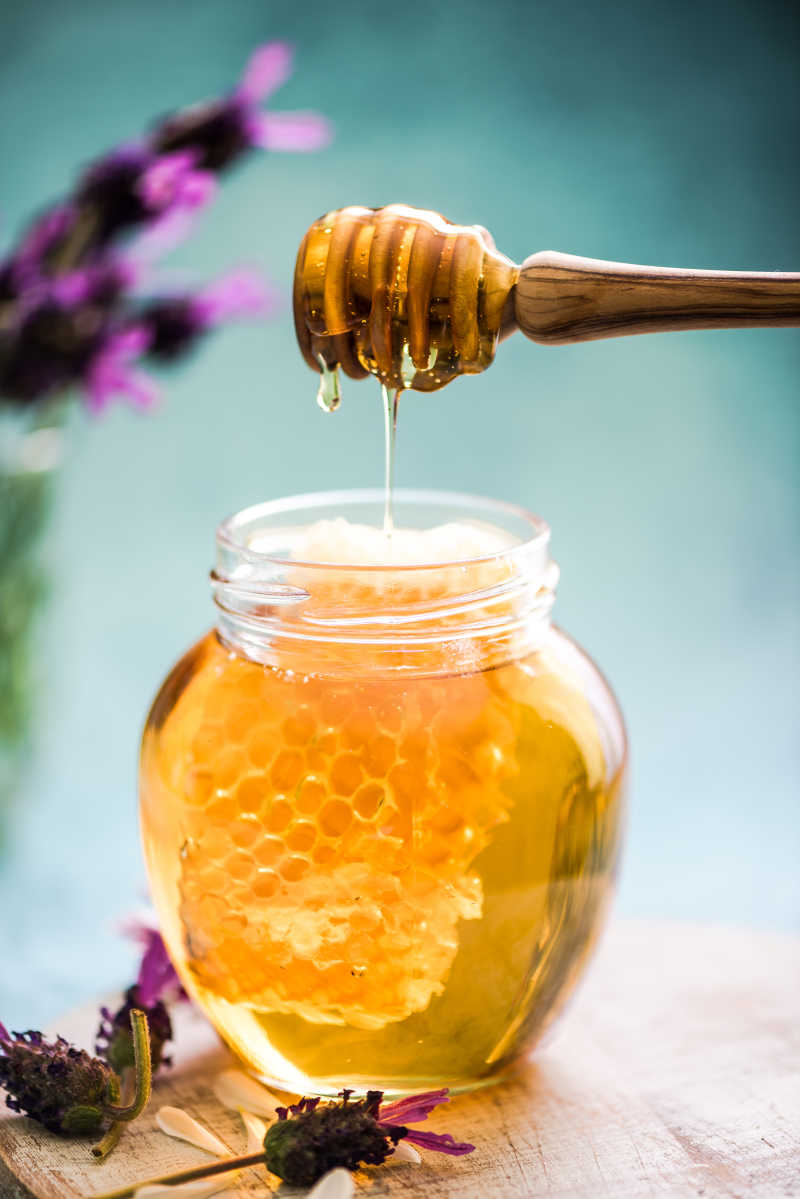 木制桌面上的蜂蜜罐