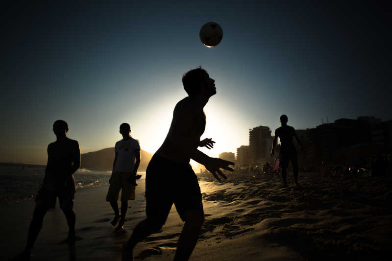 夕阳下沙滩上的排球运动