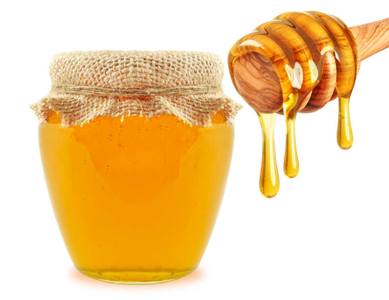 罐子里的蜂蜜和旁边的木棍
