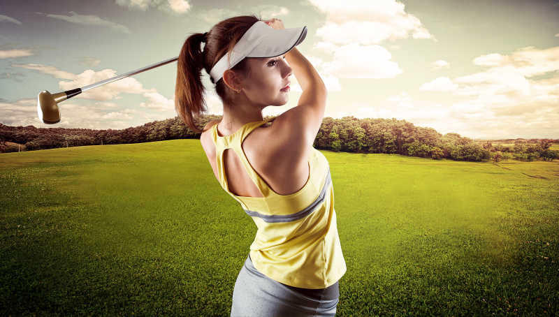 穿着运动服打高尔夫球的年轻女子
