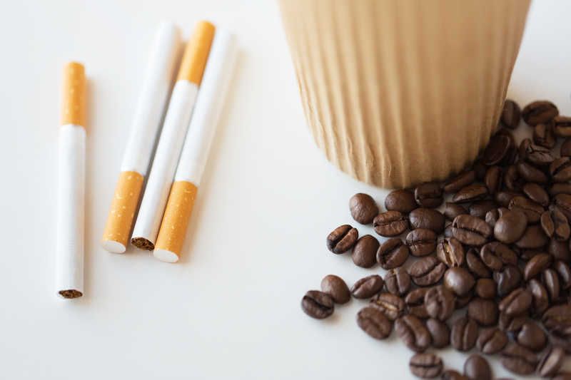 木桌上的香烟和咖啡豆