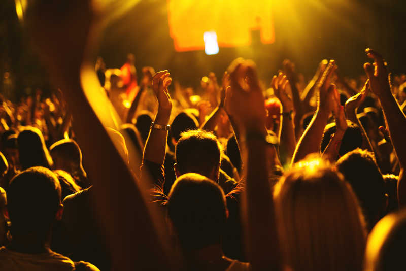 音乐会人群在空中高举双手欢呼