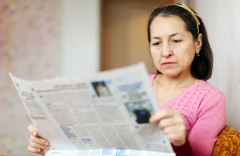 中年妇女在看报纸