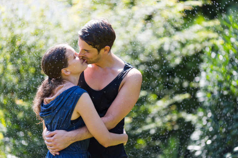 夏日草地上接吻的浪漫夫妇