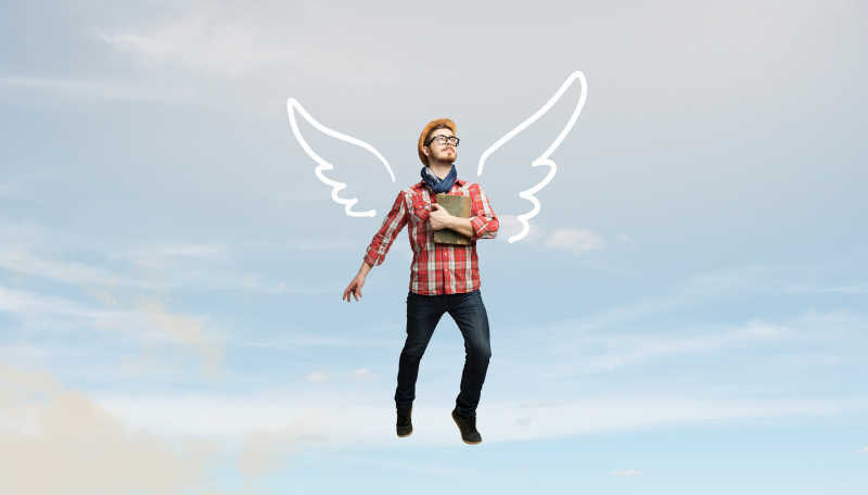 用画笔绘制的翅膀飞上天空的男人