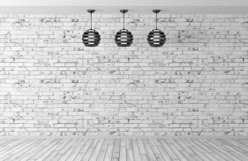 空白砖墙背景上的现代黑色吊灯