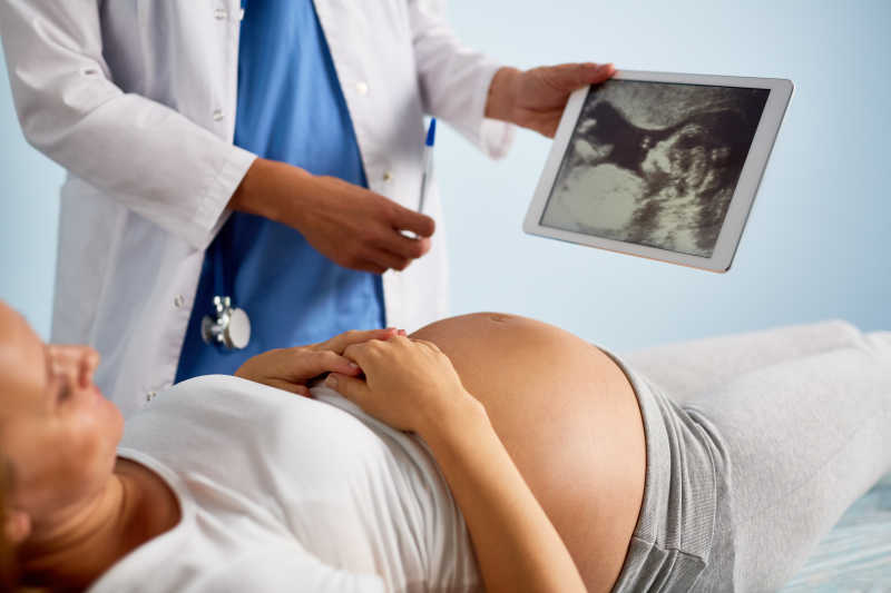 产科医生对妇女进行婴儿超声扫描