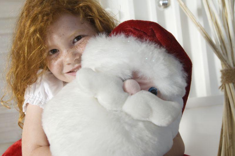 抱着圣诞老人玩偶的女孩