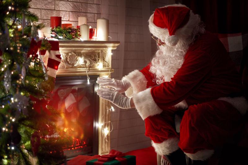 圣诞老人在火壁炉上暖手