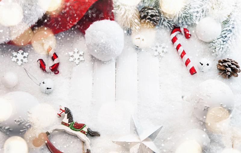 覆盖着雪花的木板上放置着各种美丽的圣诞饰品