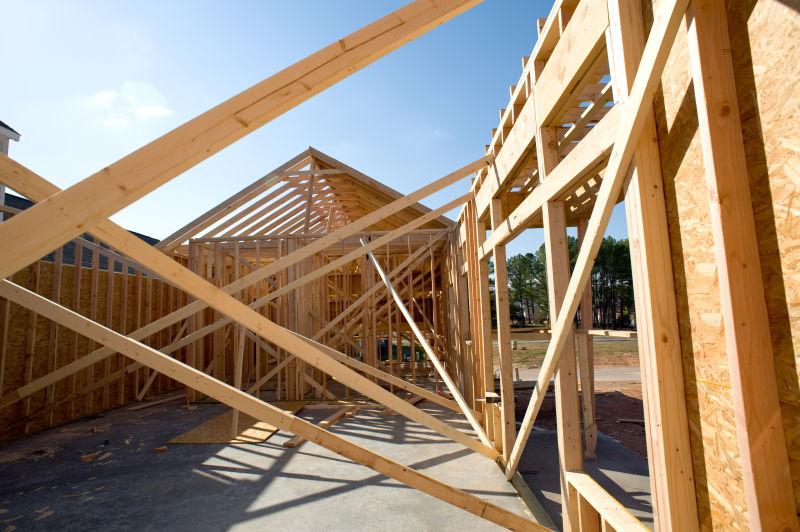 蓝天下使用木材建设中的房屋屋顶桁架