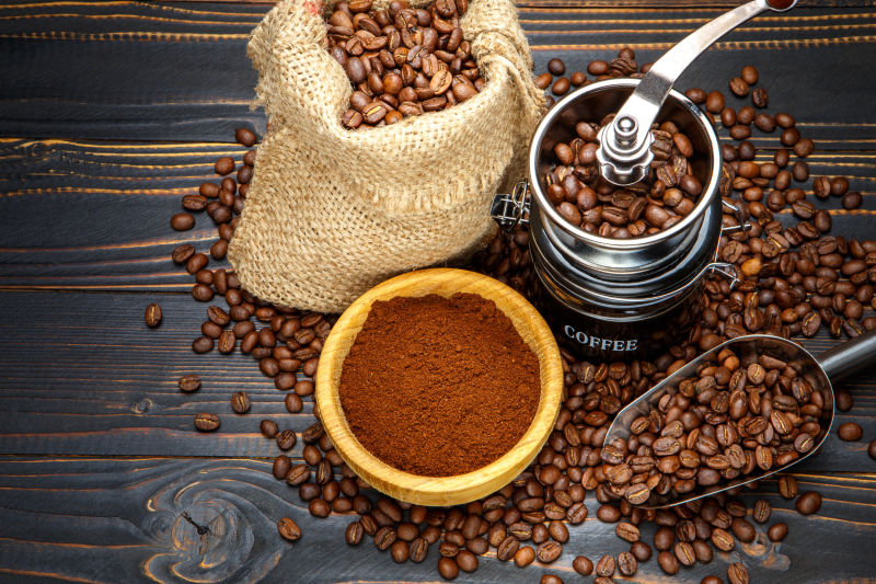 深色木制背景下的咖啡粉和咖啡豆