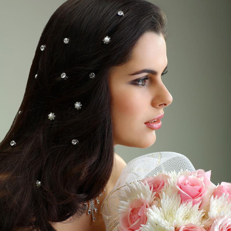 捧着鲜花的新娘带着精致的珠宝发饰