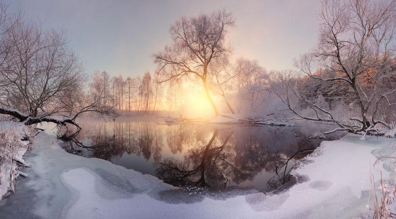 冬季白雪皑皑的湖边日出景色