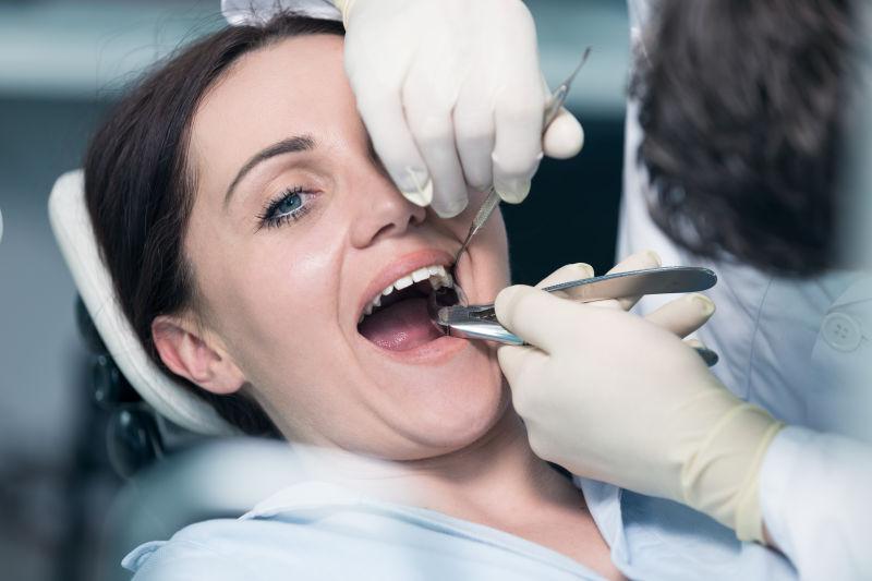 牙医正在给女病人检查牙齿
