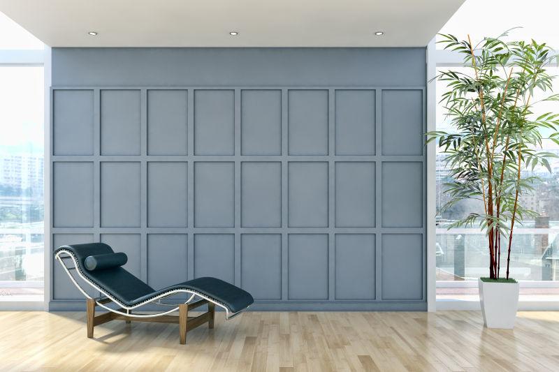 明亮的现代客厅里的灰色格子砖墙和躺椅
