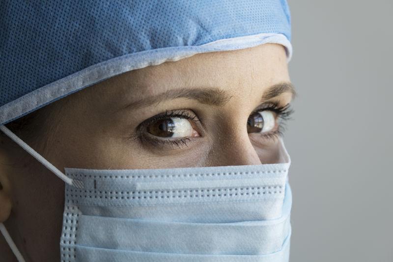 戴着防护面具的白人女性护士