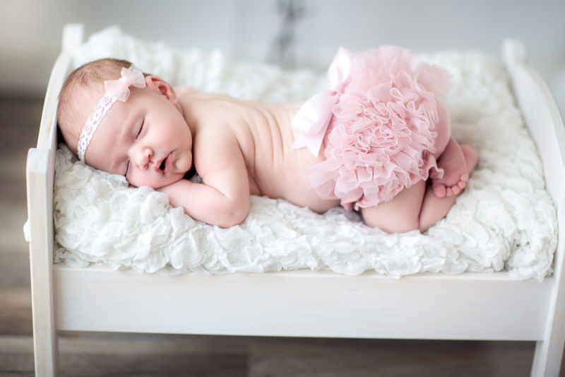 熟睡中的宝宝穿着粉色裙子