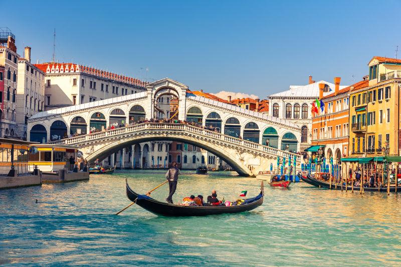 蓝天下的威尼斯里亚托桥上的贡多拉