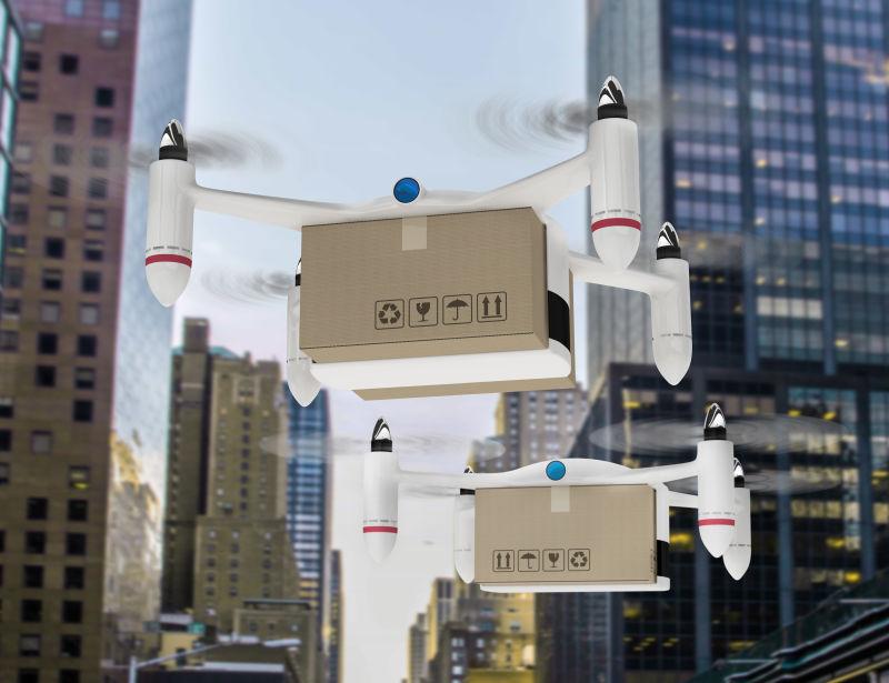 带着箱子在城市建筑空中飞的无人机