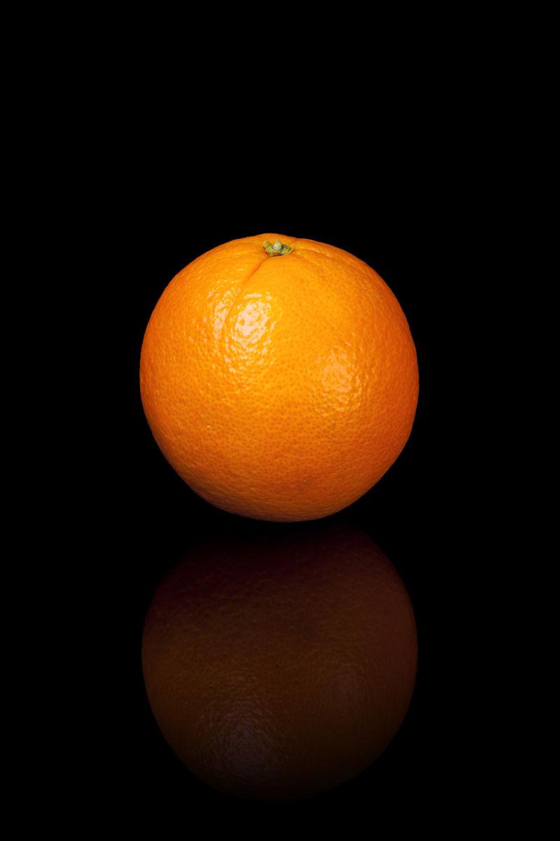 黑色反光背景下的橙子