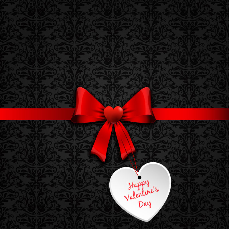有光泽的红缎带和心形标签的情人节礼物