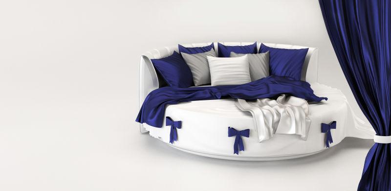 白色卧室内蓝白色的圆形床