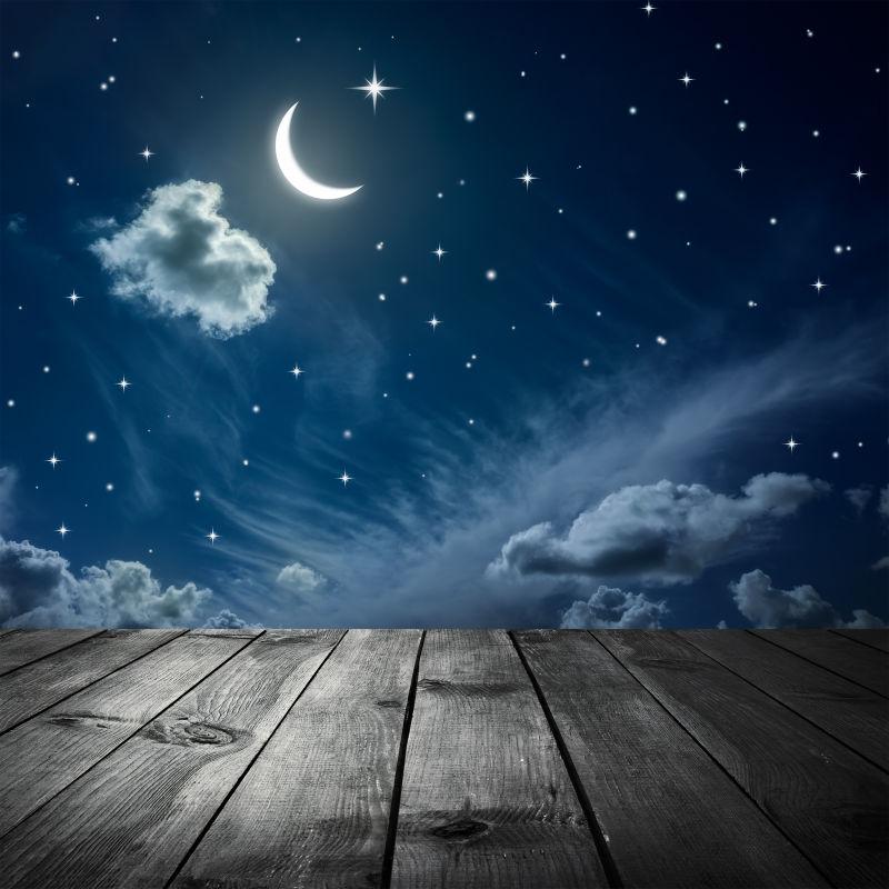 夜晚美丽星空背景前的木桌