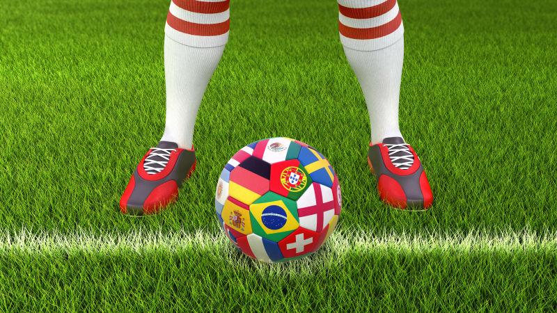 足球运动员和草地上的印刷着各个国家旗帜的足球