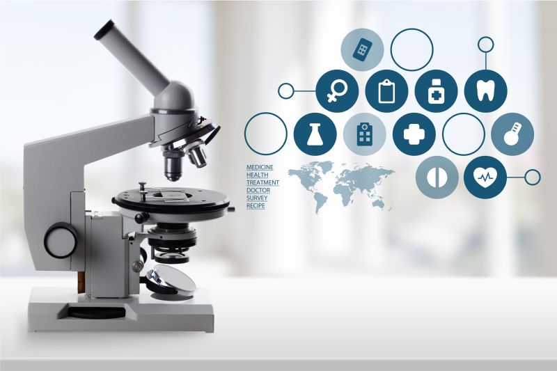 灰色背景上的显微镜和各种医疗图标