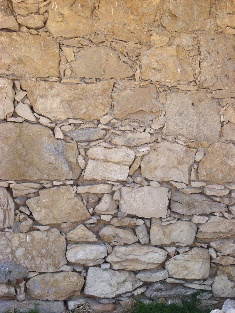 土砖头和碎石头块石墙背景