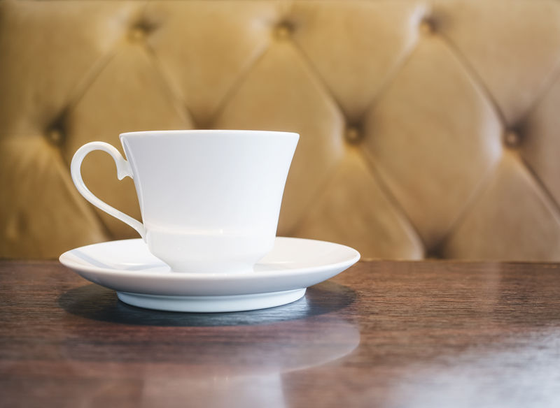 带沙发背景的餐厅咖啡厅桌上的咖啡杯